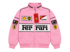 A pink Ferrari F1 racing track jacket with a full zipper, featuring the 'Ferrari' logo across the chest, 'Ferrari' and 'Puma' tags, and sponsor patches including Shell, UPS, and Castore on the front and sleeves.