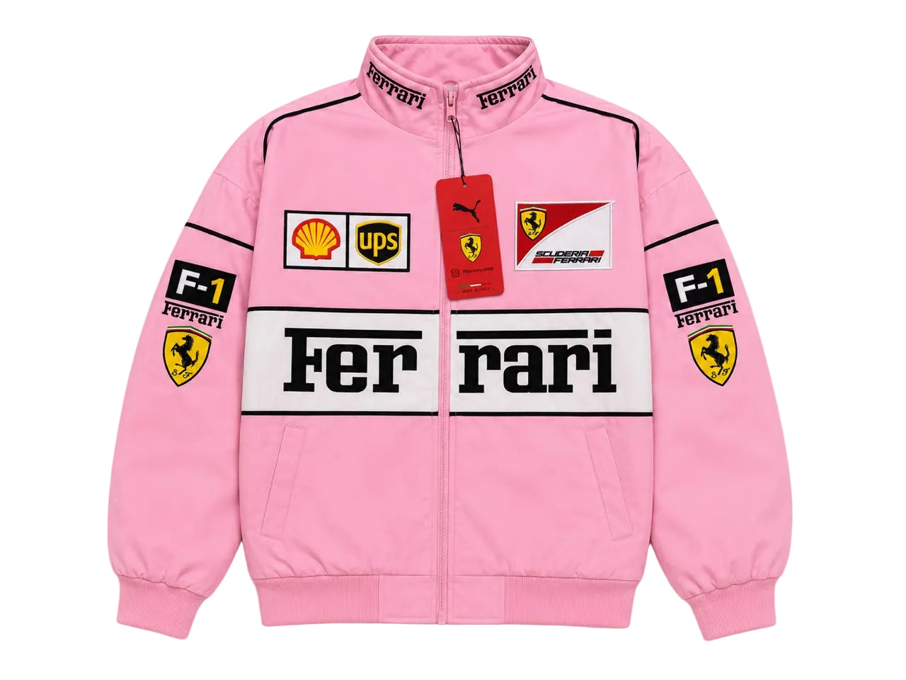 A pink Ferrari F1 racing track jacket with a full zipper, featuring the 'Ferrari' logo across the chest, 'Ferrari' and 'Puma' tags, and sponsor patches including Shell, UPS, and Castore on the front and sleeves.
