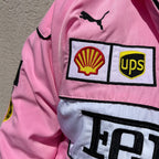 Pink jacket with Shell, UPS, and Ferrari logos on a plain background